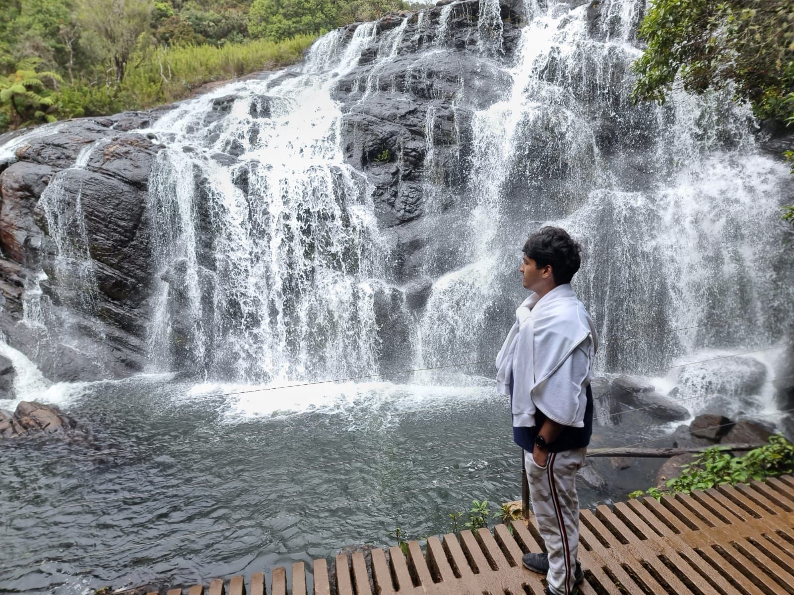 Person standing infront of a waterfall